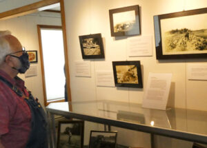 Viewing photos and artifacts at the My Island Home Exhibit